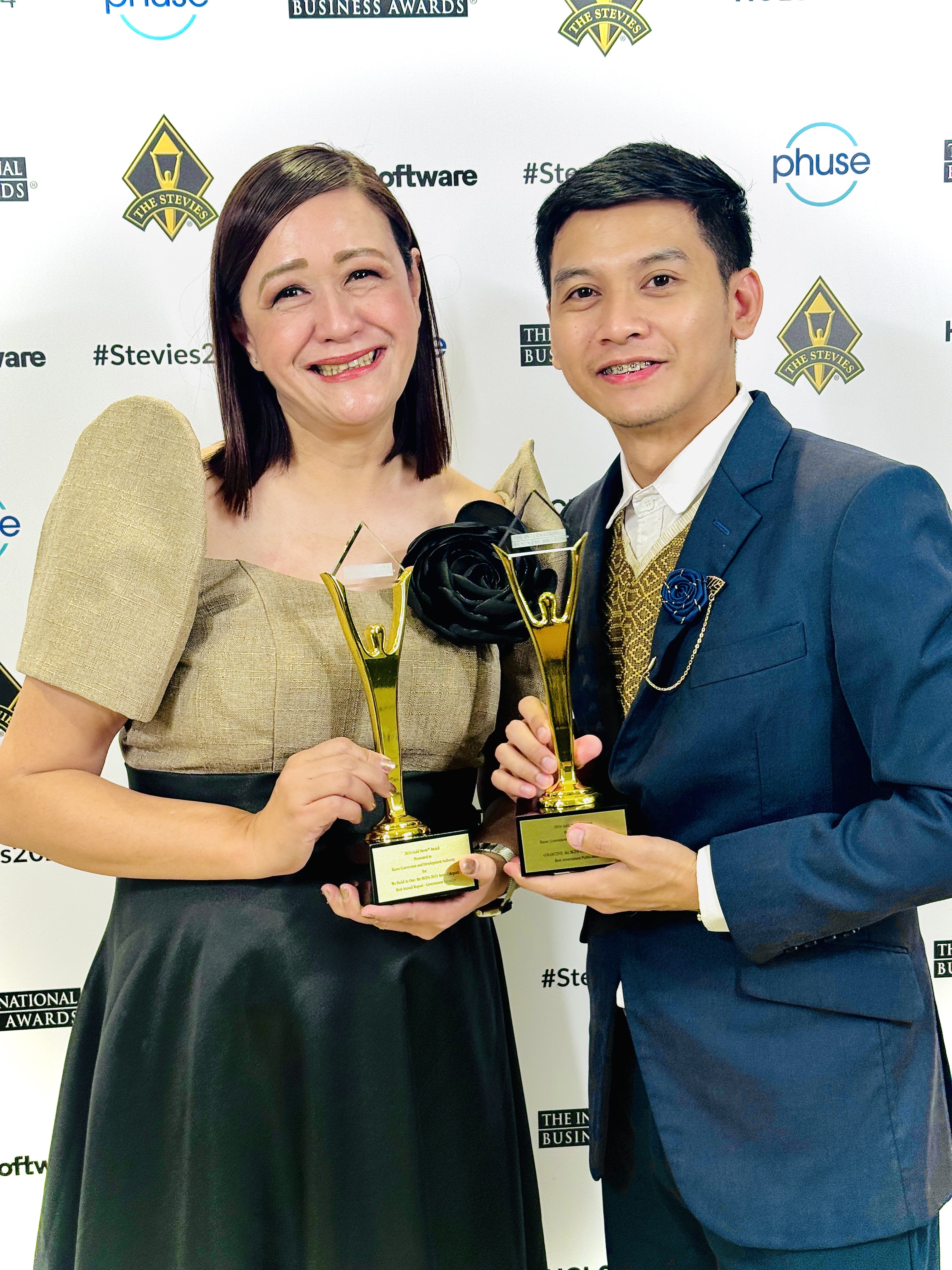 two people holding the award