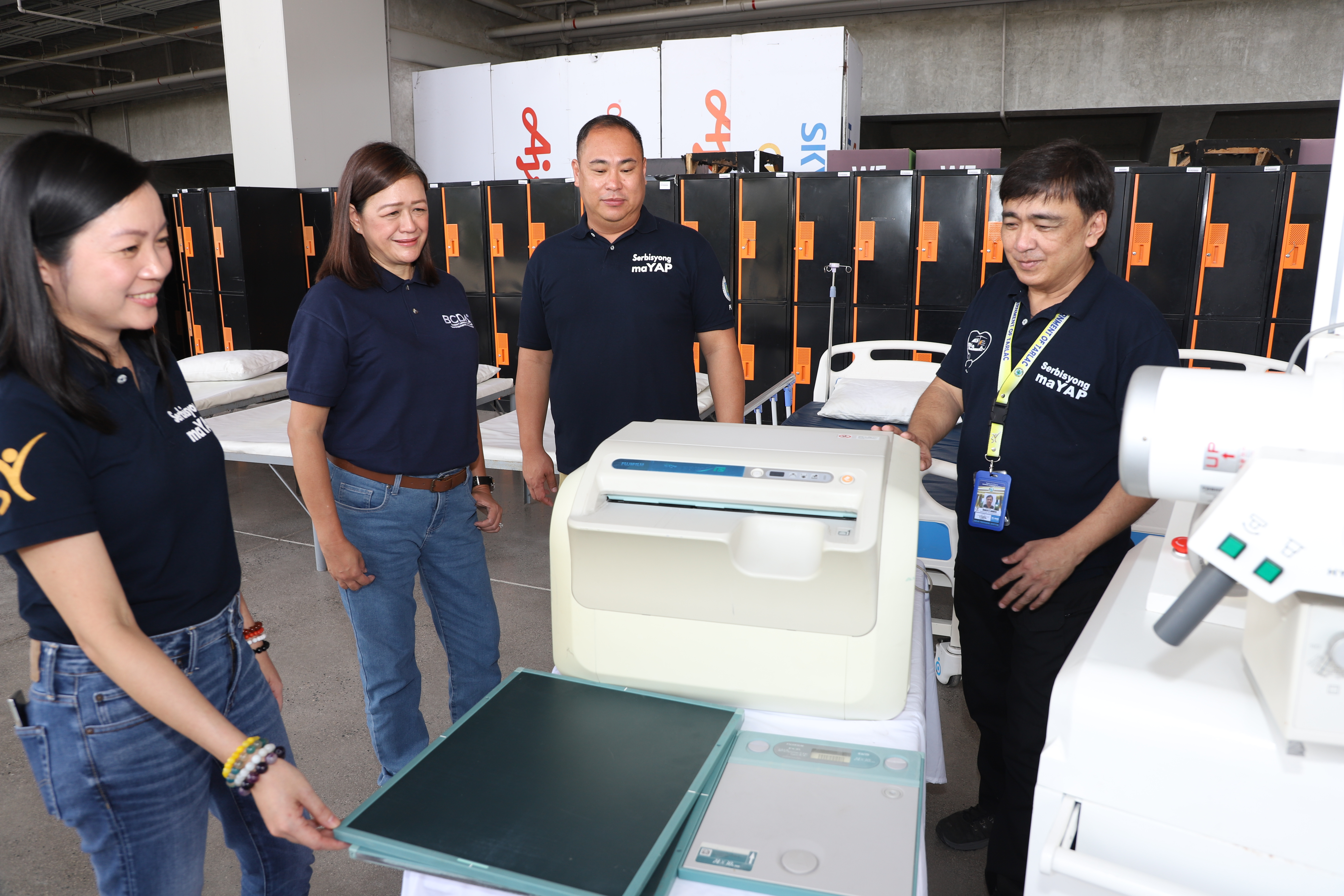 Photo caption: Representatives from the Tarlac Provincial Capitol inspect the donated medical equipment from the Bases Conversion and Development Authority. BCDA photo